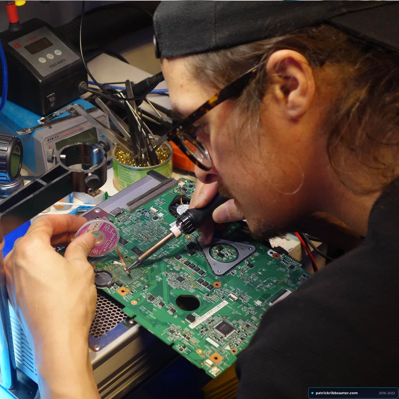 Patrick Ribbsaeter Soldering and Desoldering Pads on Laptop Motherboard with Copper Wick